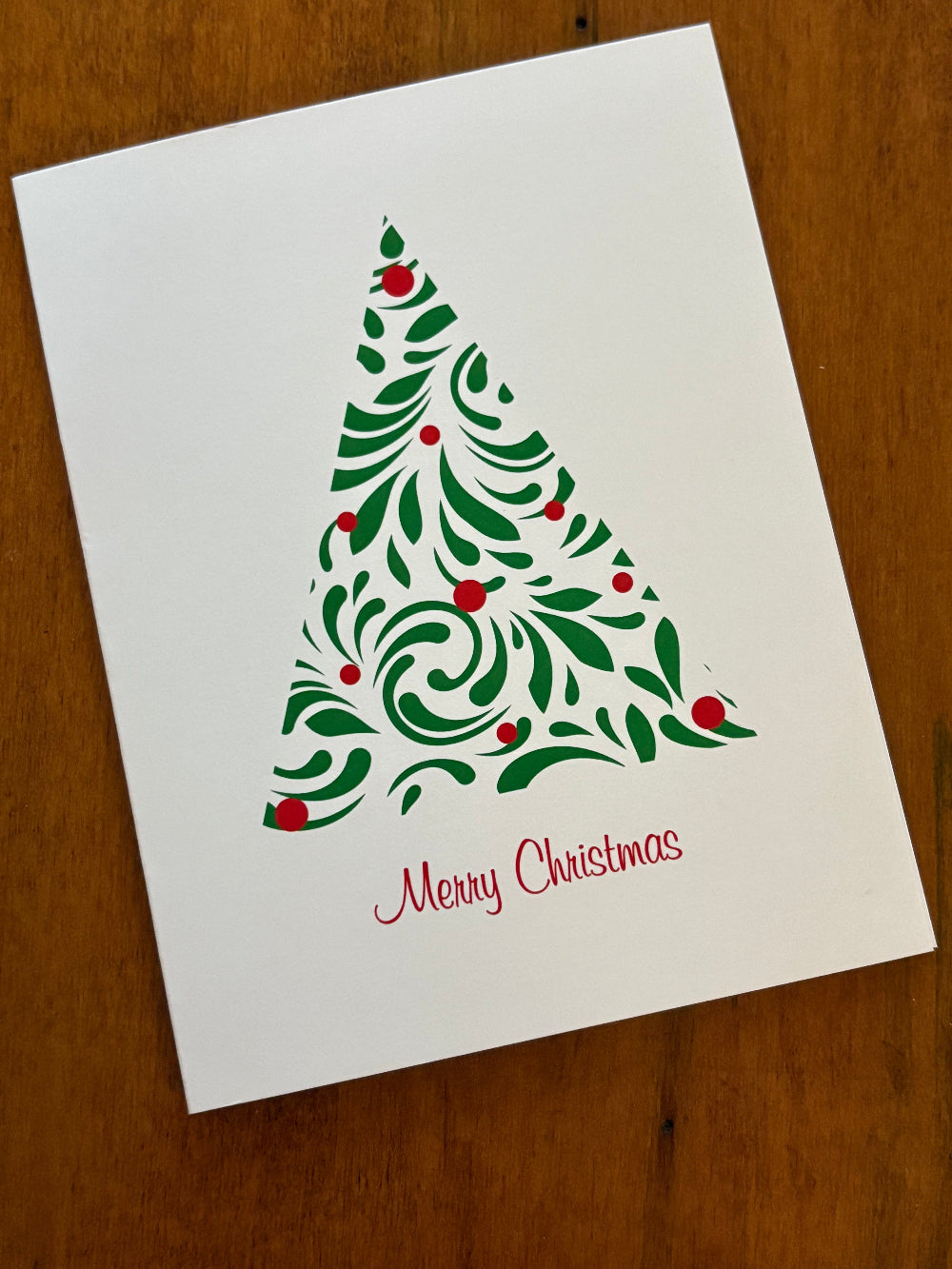 Christmas-themed greeting cards with A modern green tree with red balls design and text 'Merry Christmas' in red