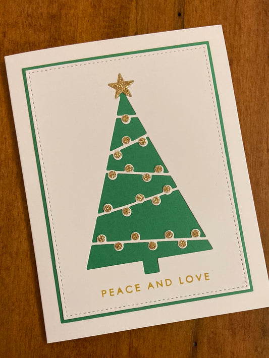 Handmade Christmas card with modern graphic Christmas tree in green, white, and gold monochrome design