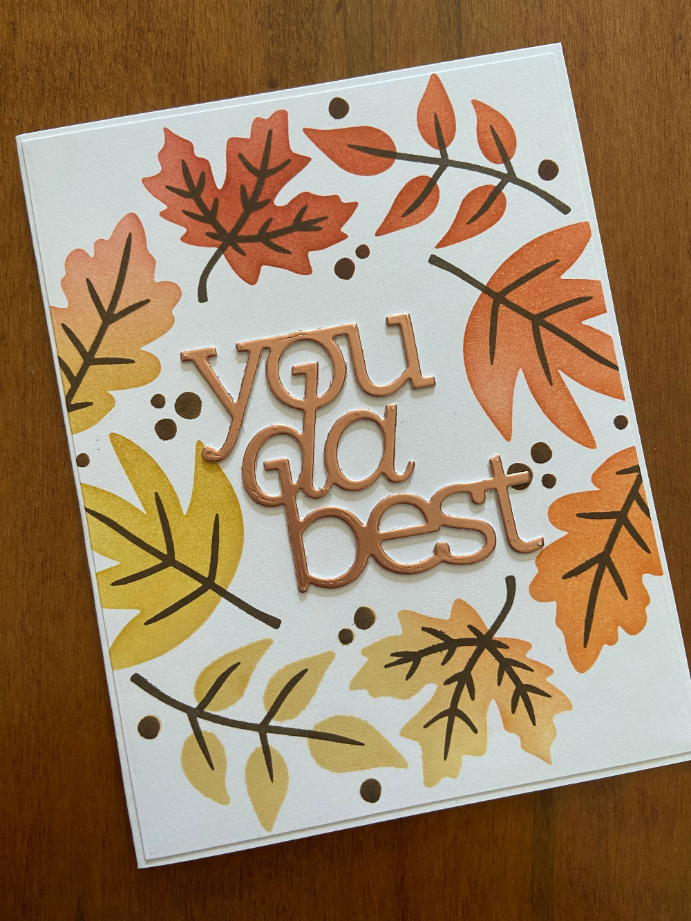 Handmade encouragement card with autumn leaves wreath in orange, red, and yellow with 'you da best' sentiment in centre.